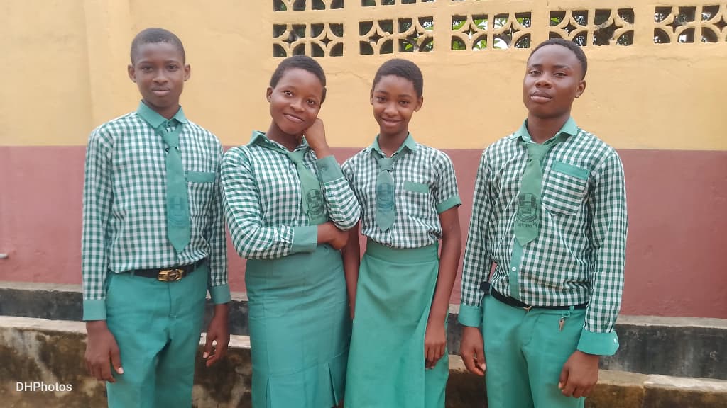 Chez Mican Schools students in uniform outside the classroom block