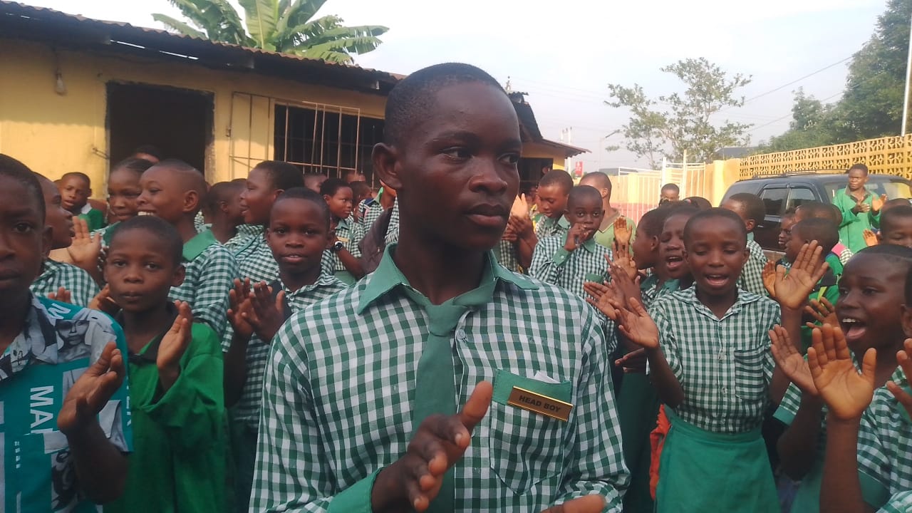 The head boy leading fellow students during a school event