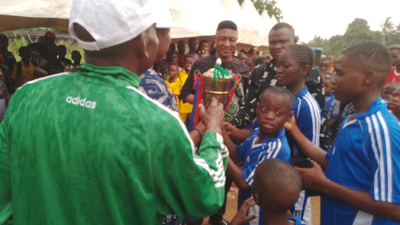Students celebrating with trophies at a Chez Mican Schools sports event